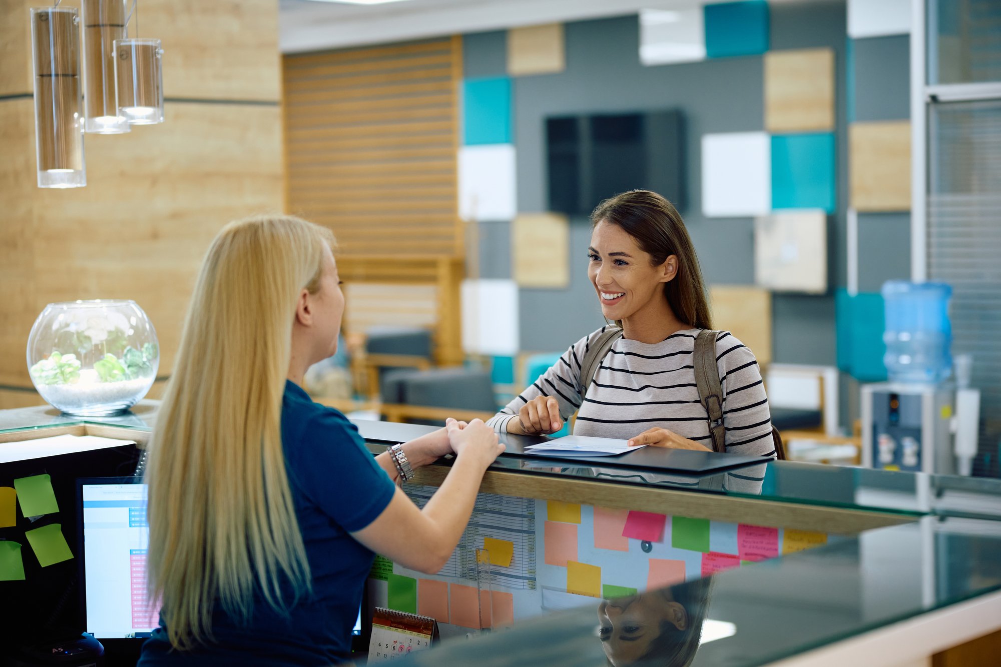 student talking to front desk person